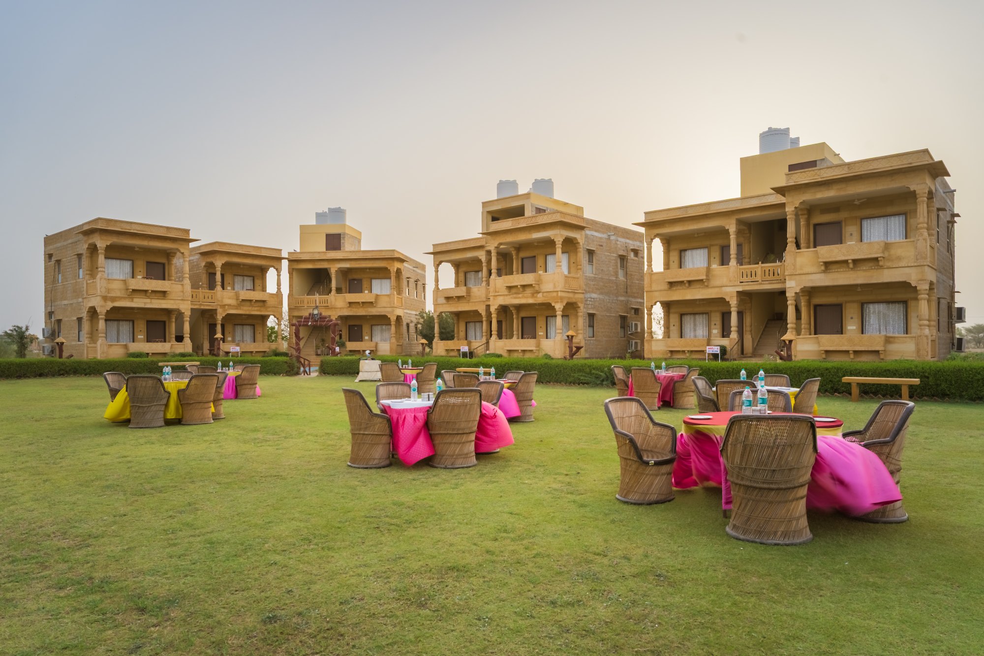 Moonlight Nature Resort at dusk, sandstone havelis lit above the lawn
