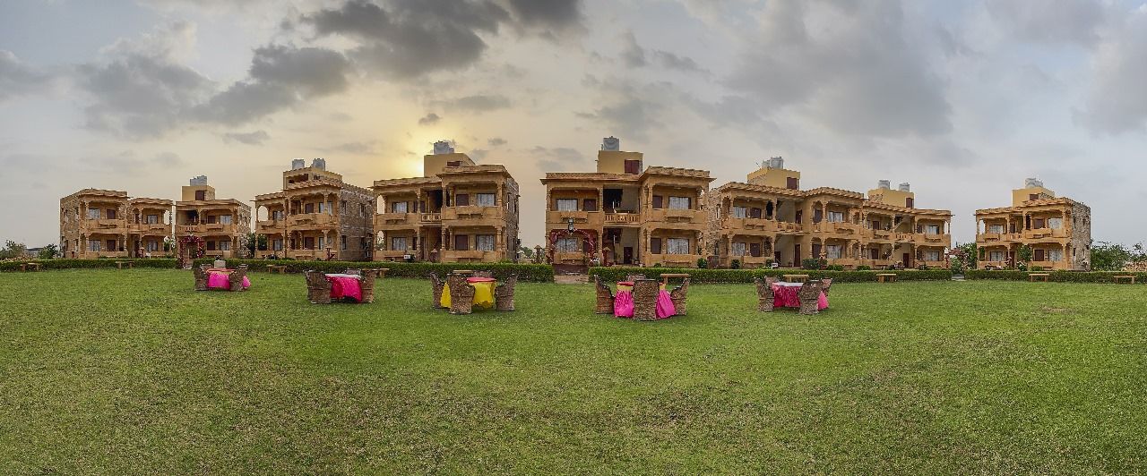 Sandstone havelis and open lawn at Moonlight Nature Resort