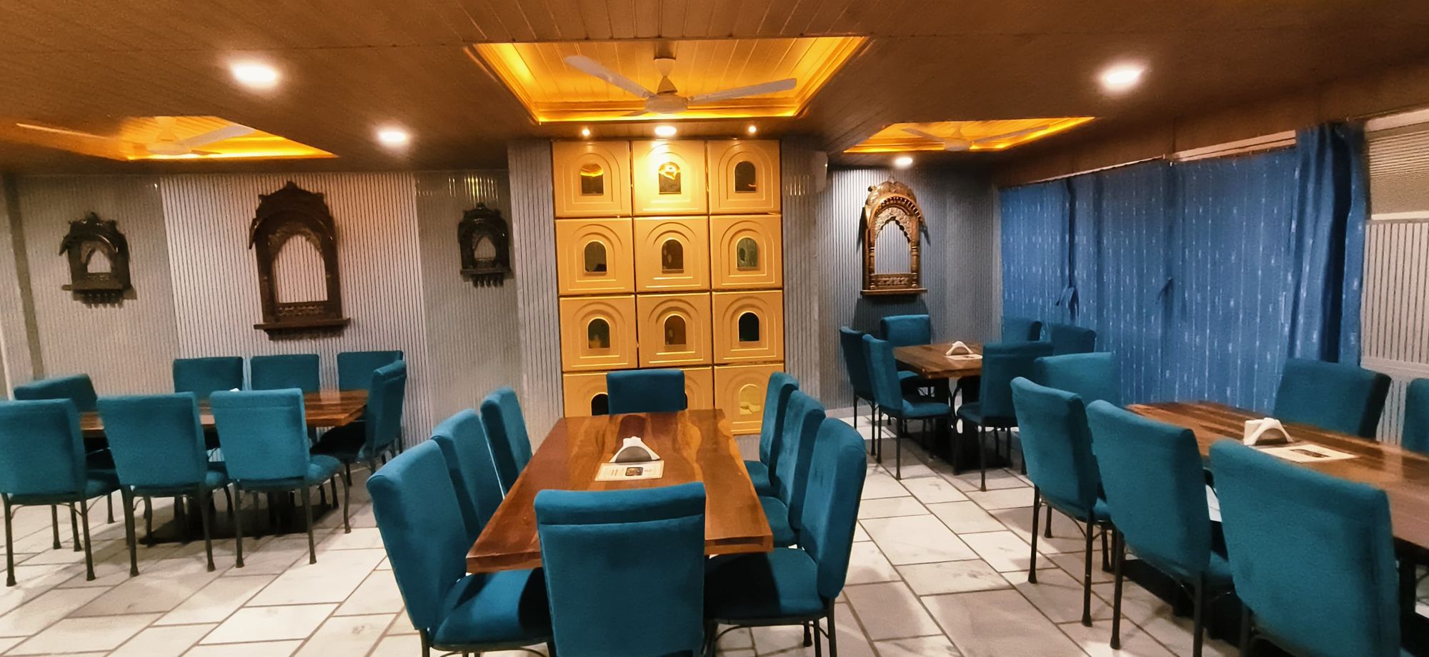 Dining room at Hotel Moonlight with carved jharokha panels and warm lighting